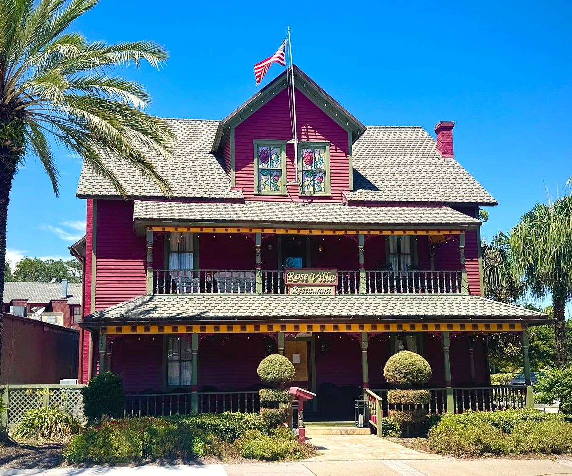 The historic Rose Villa restaurant in Ormond Beach, with its rose-colored exterior and welcoming front porch.